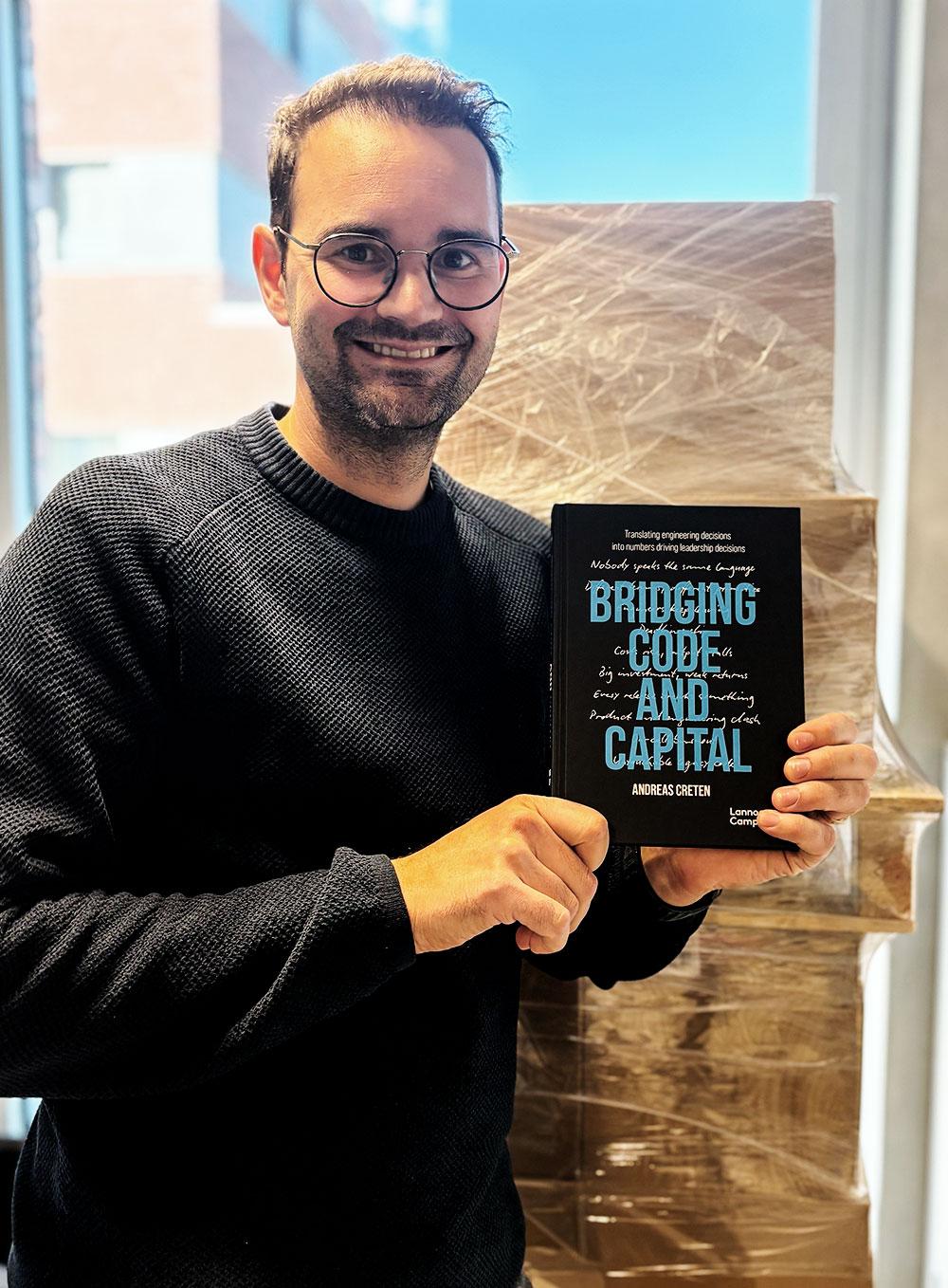 Andreas Creten holding his book, The economics of Software engineering